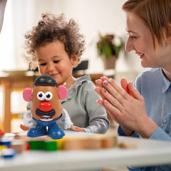 MrPotatoHeadSeries Child playing with mix-and-match set for shared fun.