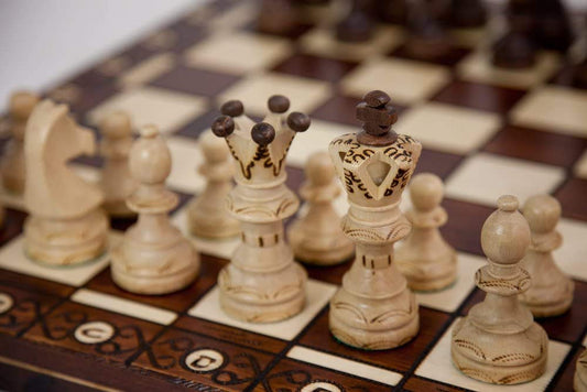 Muba hand-carved chess pieces close-up showing weighted felt-bottom detail