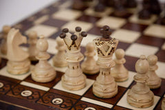 Muba hand-carved chess pieces close-up showing weighted felt-bottom detail