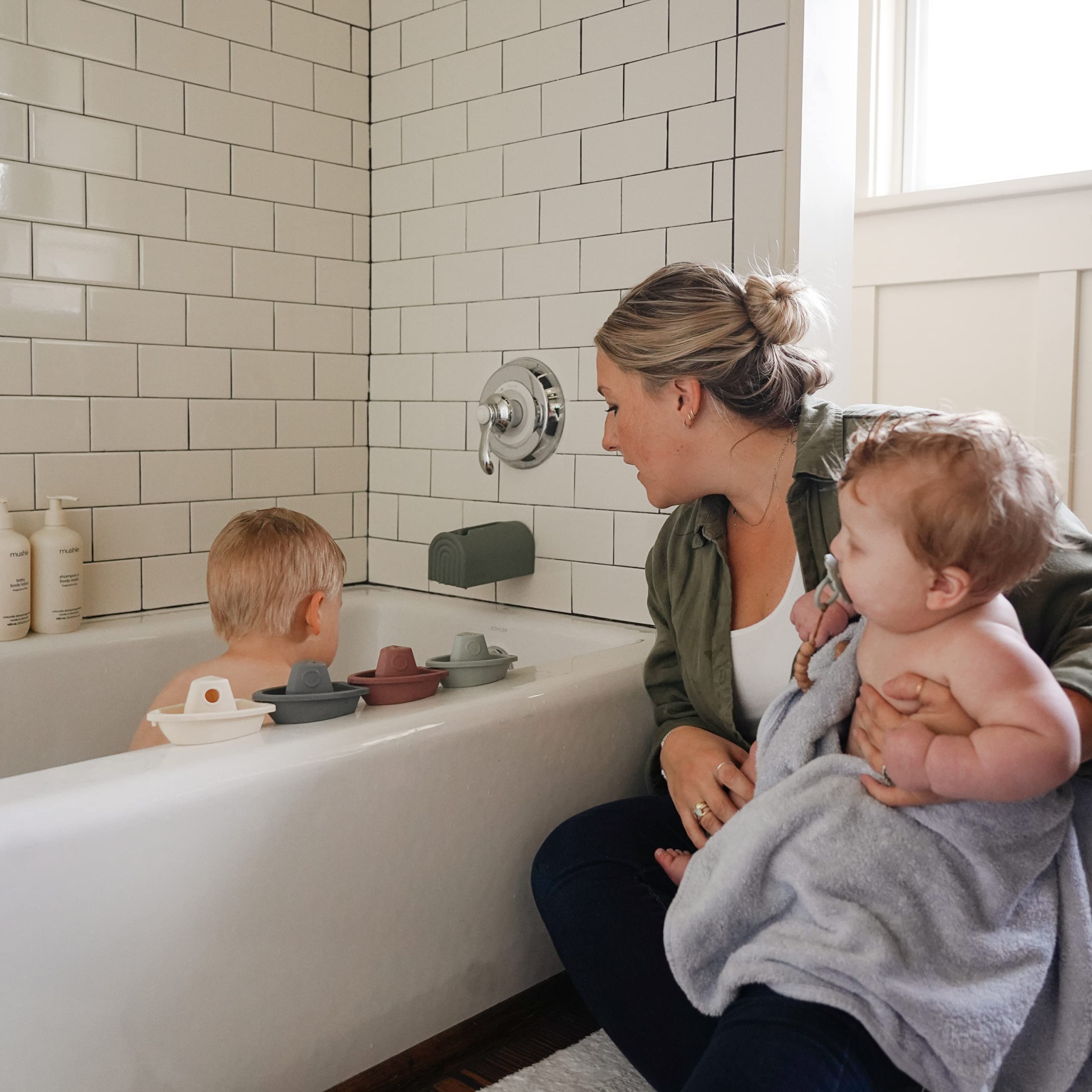 Mushie bath boats help develop fine motor skills during water play.