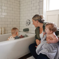 Mushie bath boats help develop fine motor skills during water play.