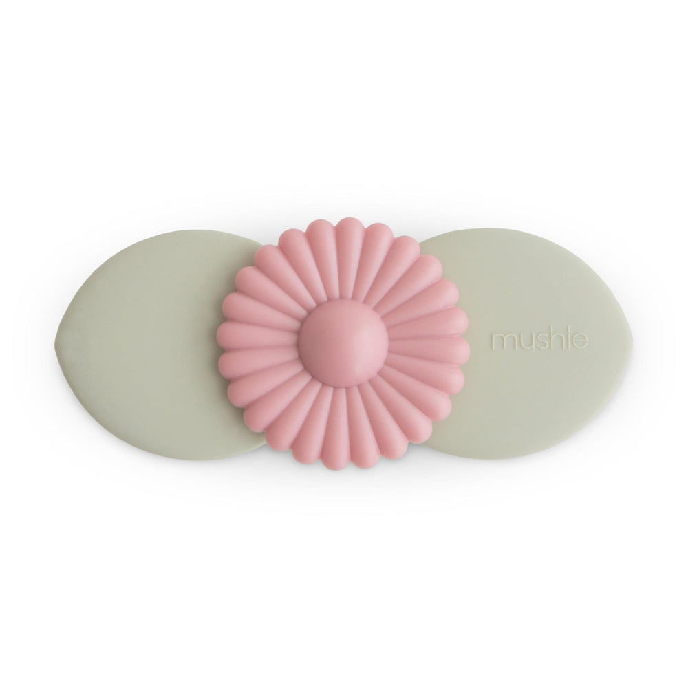 Mushie Blossom suction spinner toy on bath tub surface with spinning leaves for bath time exploration