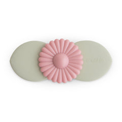 Mushie Blossom suction spinner toy on bath tub surface with spinning leaves for bath time exploration