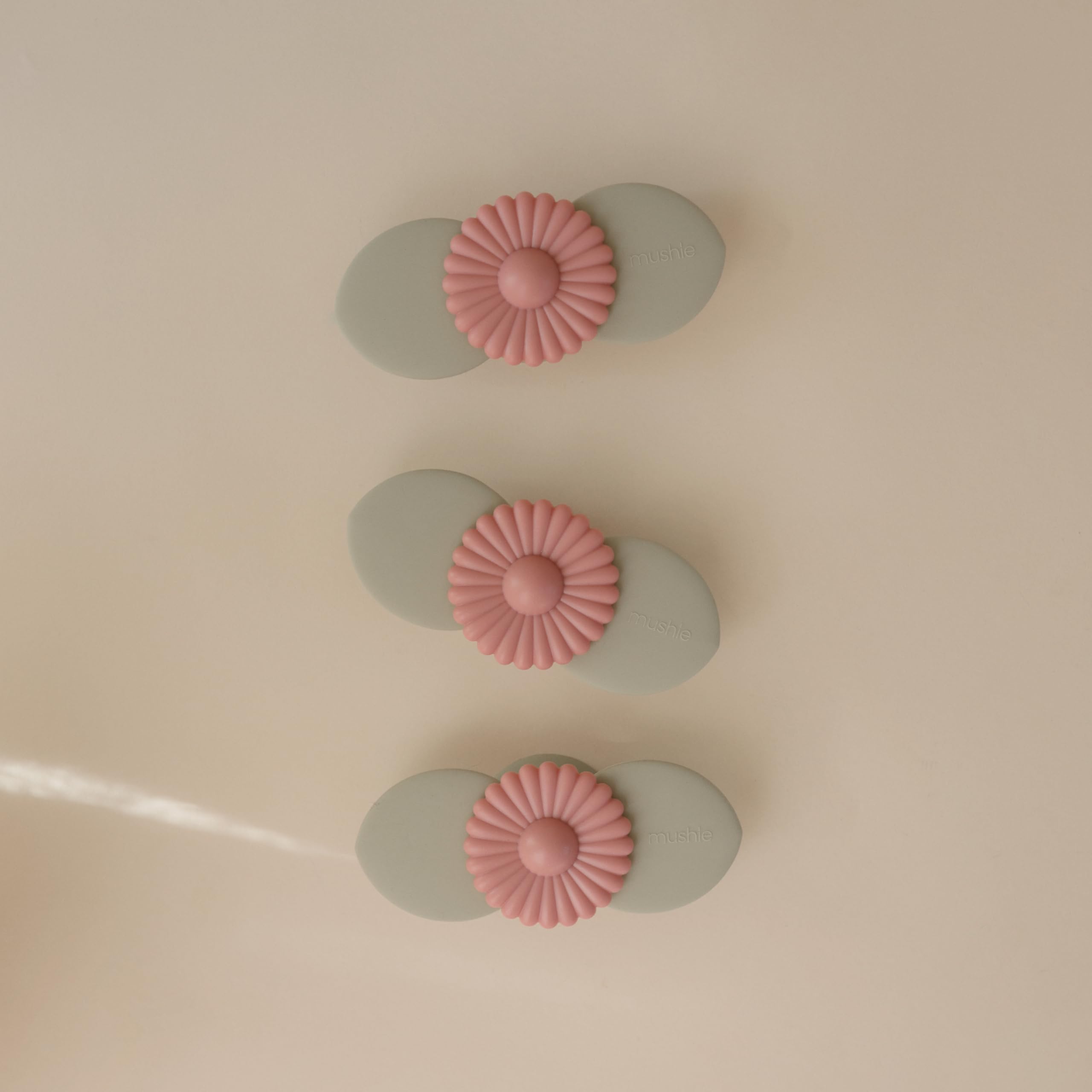 Mushie Blossom suction spinner on a highchair tray promoting focused independent play