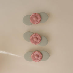 Mushie Blossom suction spinner on a highchair tray promoting focused independent play