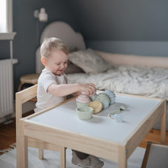 Mushie cupcake shapes on table illustrating family friendly toy set