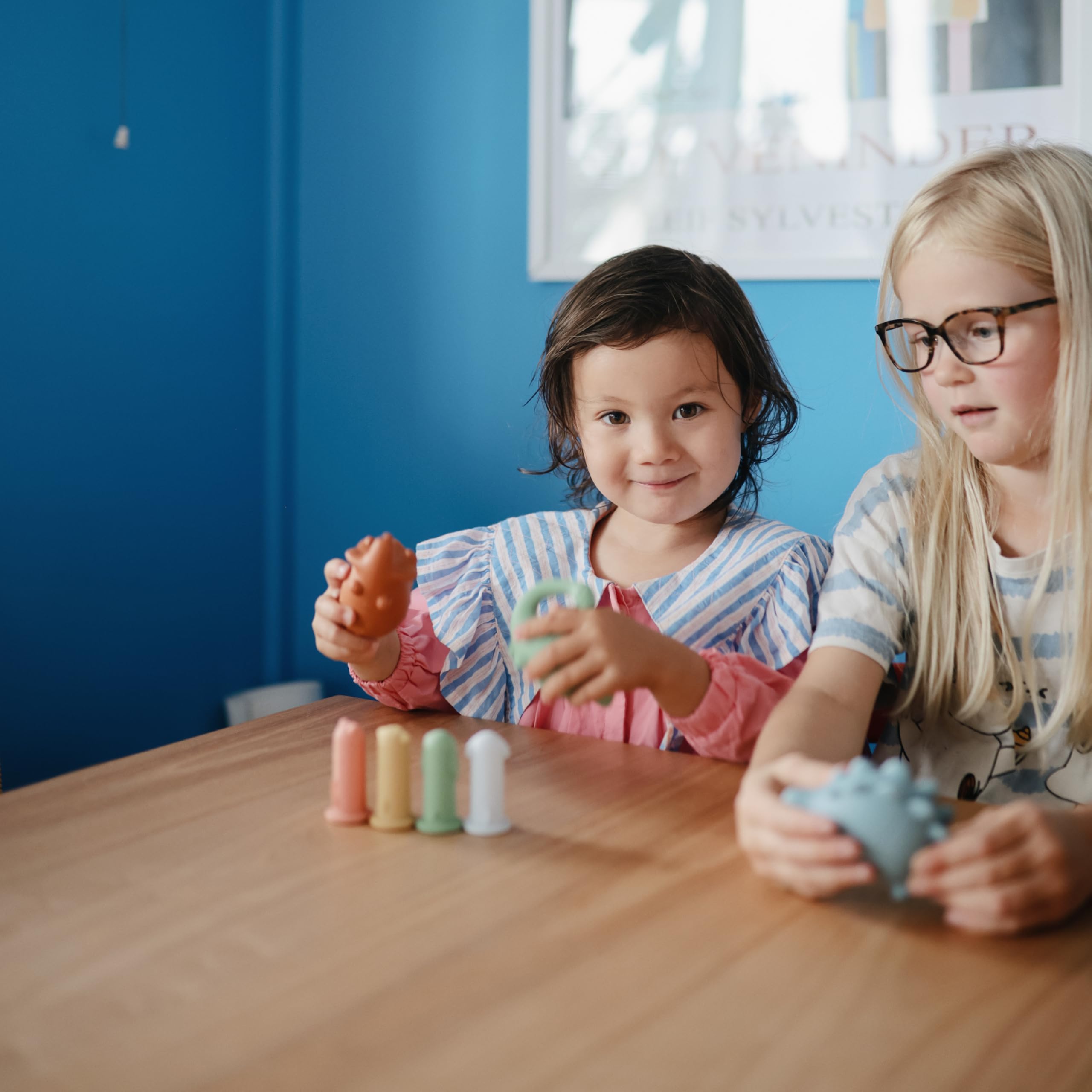 Mushie Dino Bath Toy is made of soft silicone for little hands.