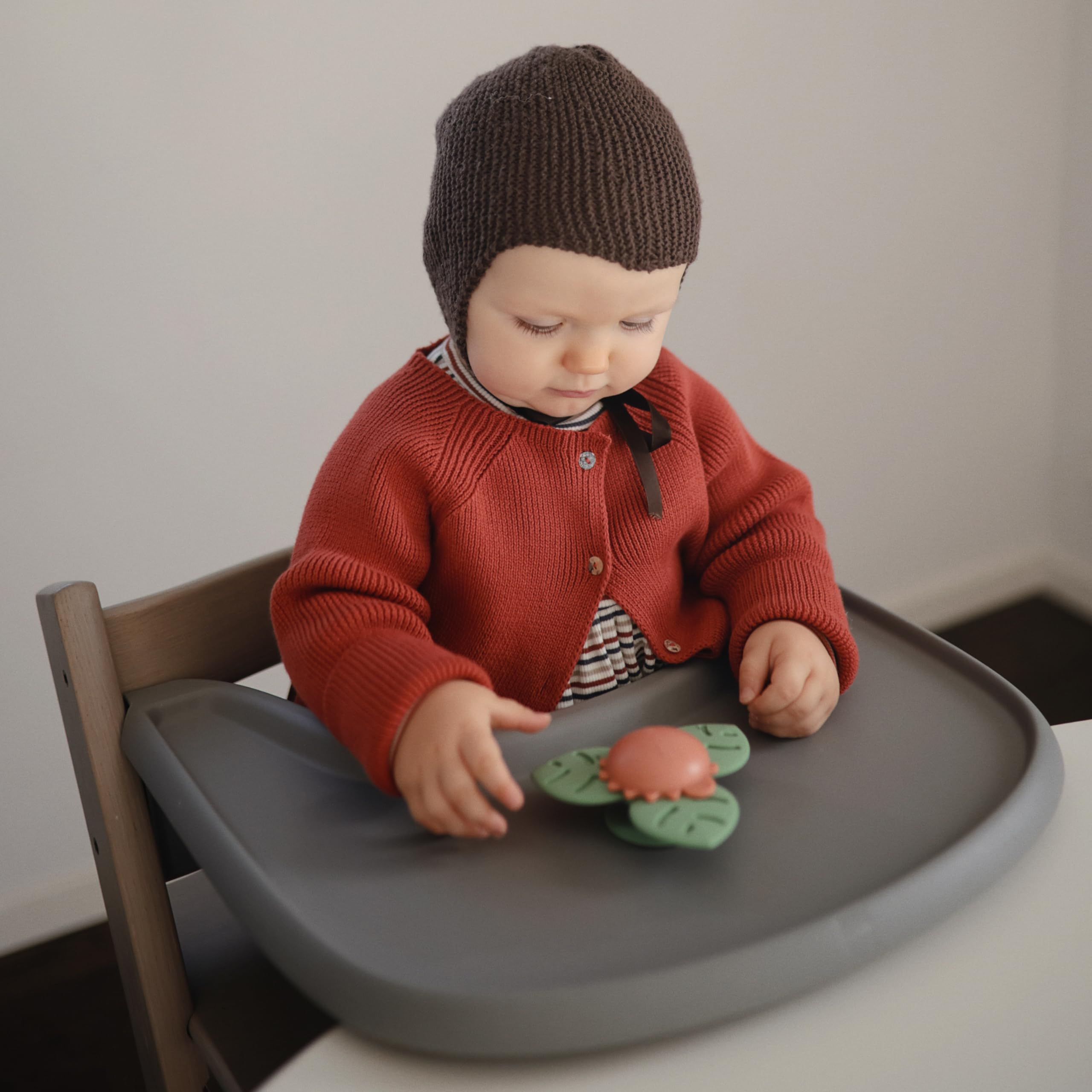 Mushie Dino Suction Spinner Toy close-up shows silicone leaves for tactile exploration