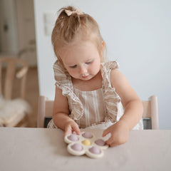 Mushie Flower Press Toy BPA-free frame in action during play