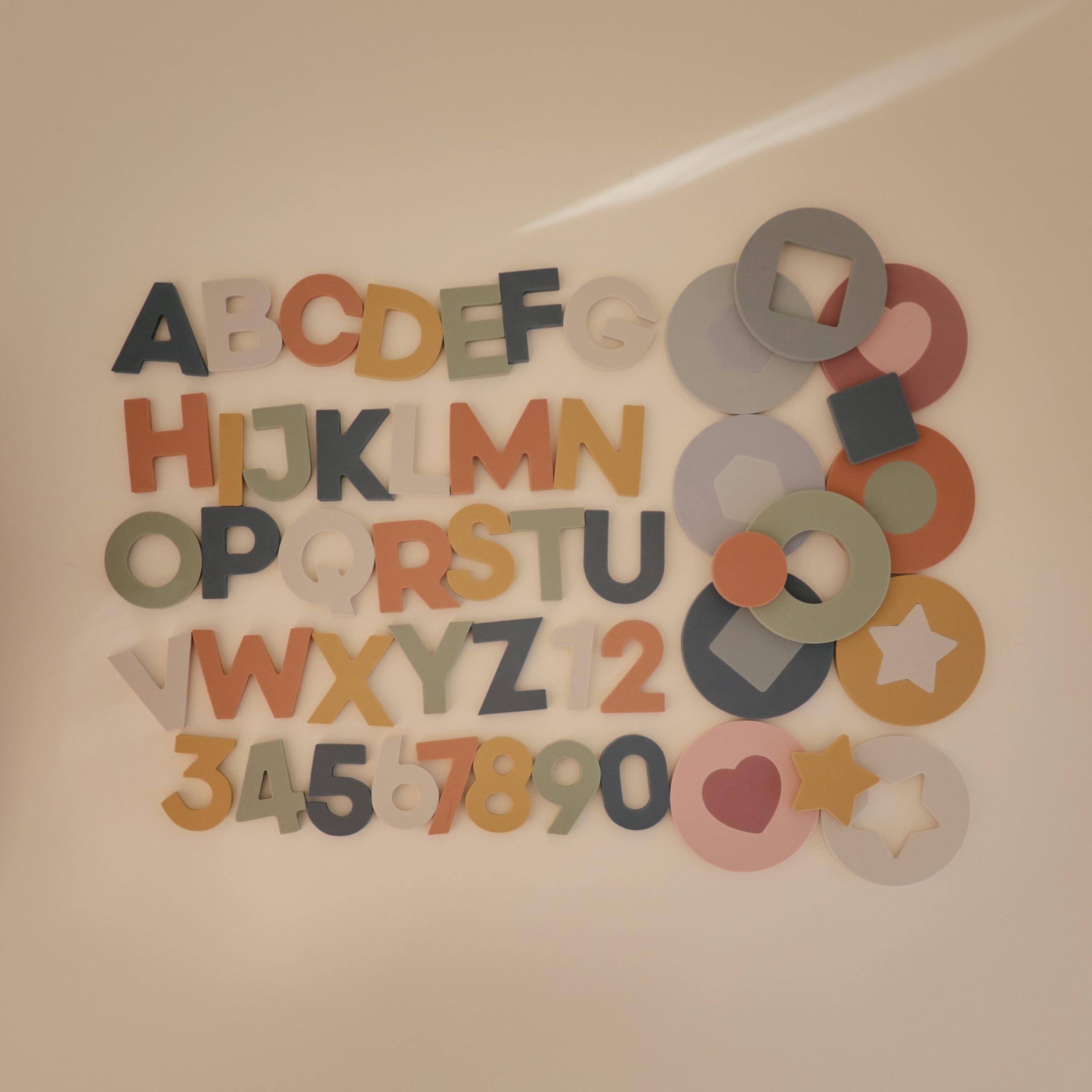 Mushie bath puzzle pieces stick to surfaces for interactive tub play