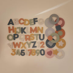 Mushie bath puzzle pieces stick to surfaces for interactive tub play