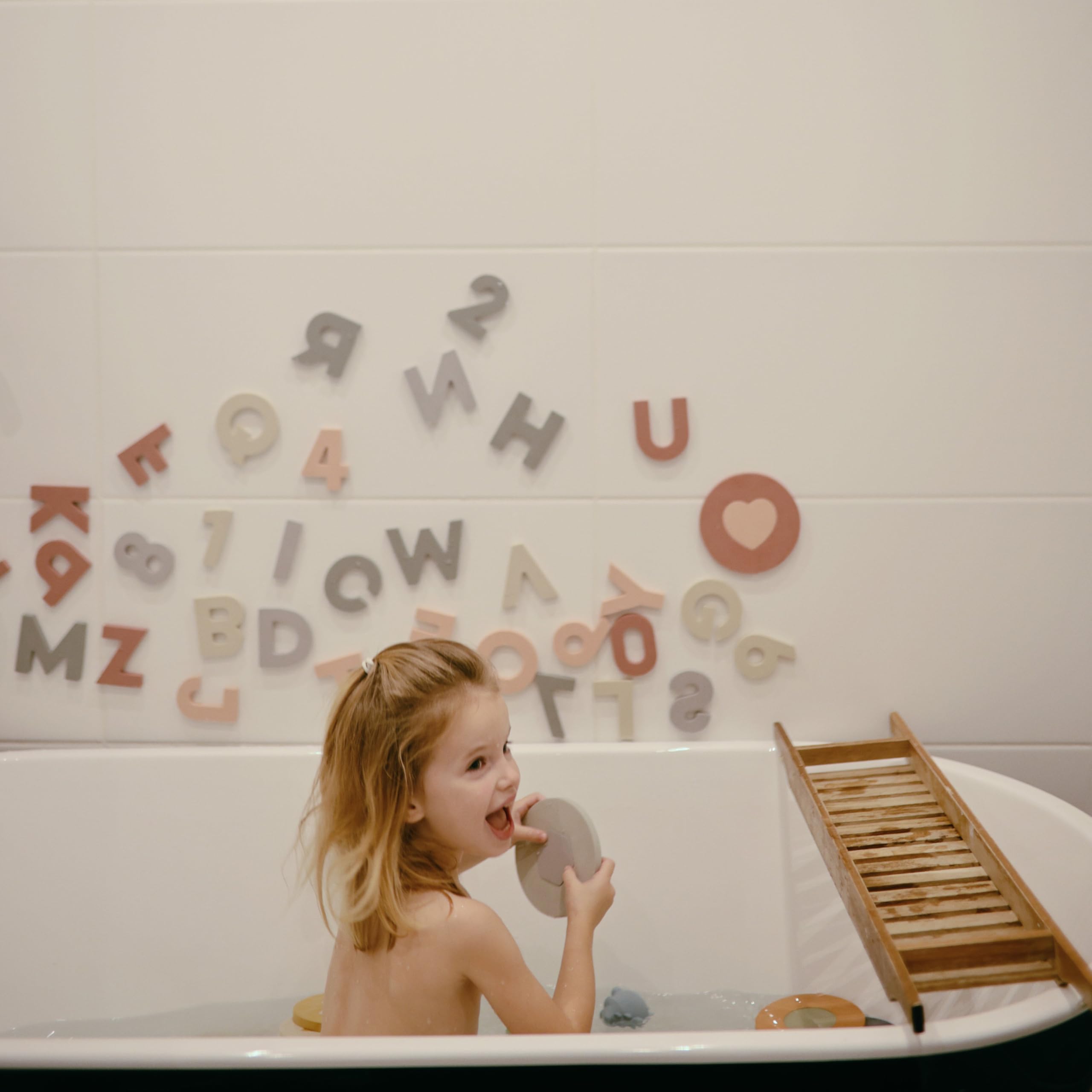 Mushie foam bath puzzle supports fine motor skills with shape fitting