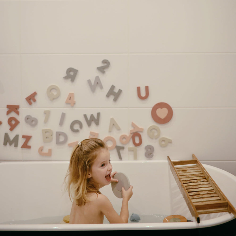 Mushie foam bath puzzle supports fine motor skills with shape fitting