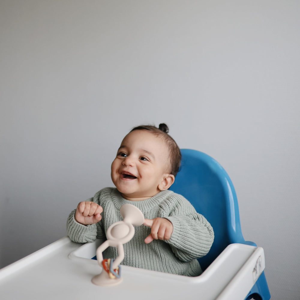 Mushie HexaPop sensory toy features charms and bubble detail