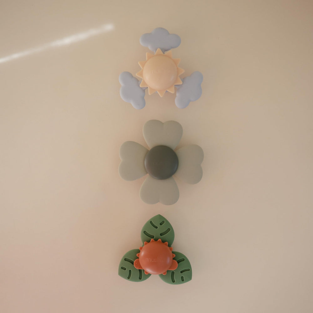 Mushie Lucky Suction Spinner Toy adheres to airplane tray during travel.