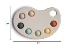 Mushie Paint Palette Press Toy showcases calming colors during playtime.