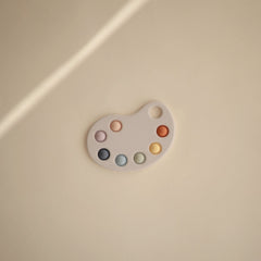 Mushie Paint Palette Press Toy children’s hands press bubbles for fine motor skills.