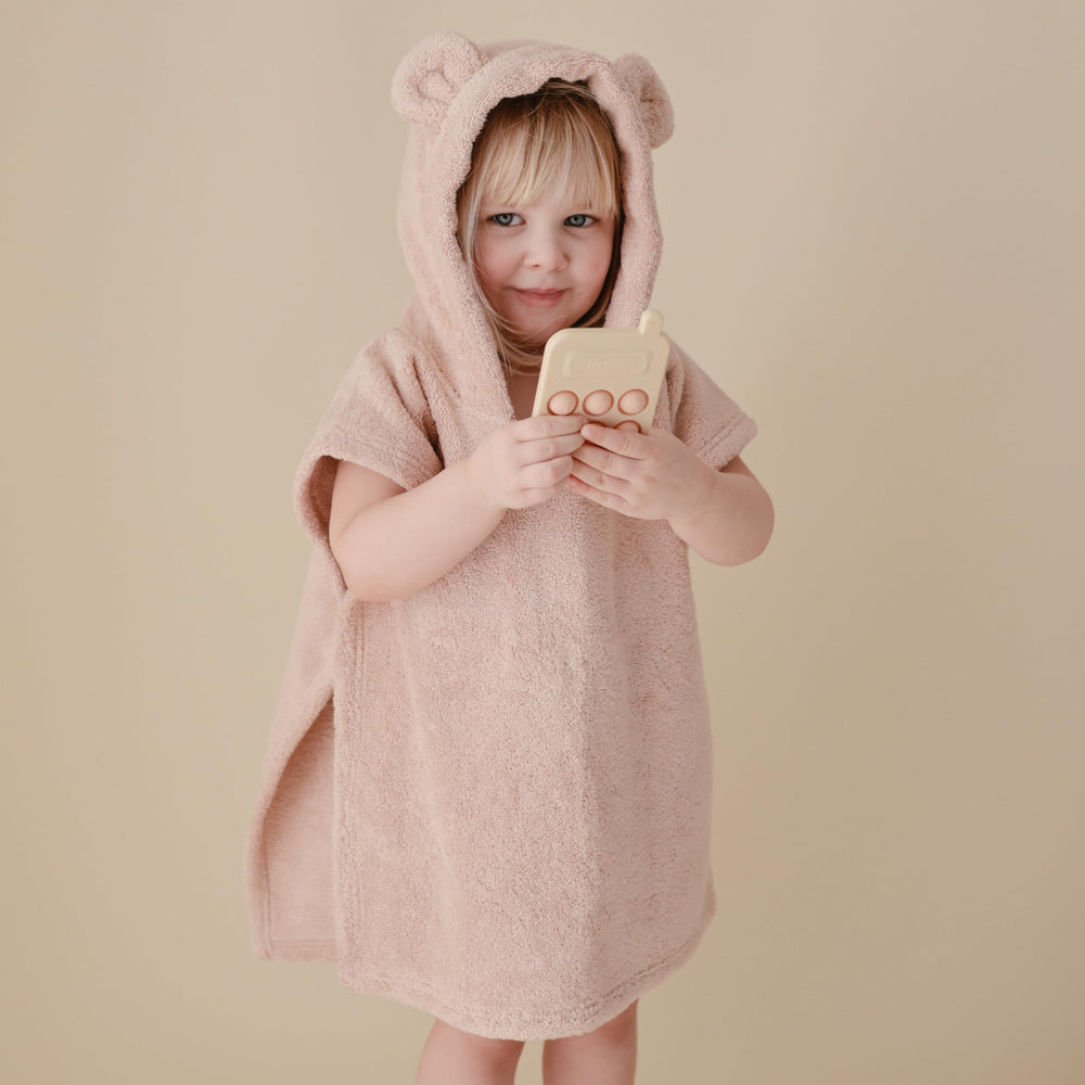 Mushie Phone Press Toy Blush resting on a playmat for tactile time