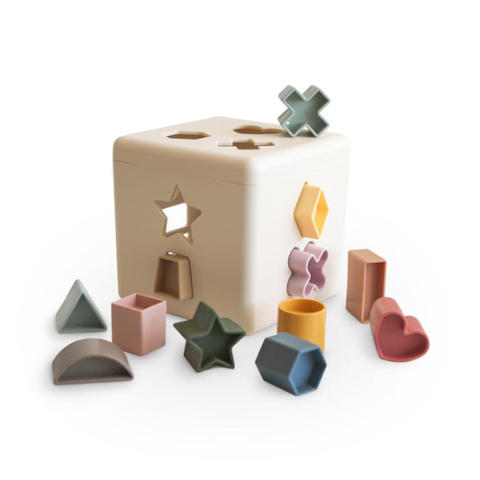 Mushie shape sorting box with 12 shapes for toddler learning and sensory play