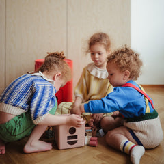 Mushie Shape Sorting Box Petal with lid open encourages hands-on exploration