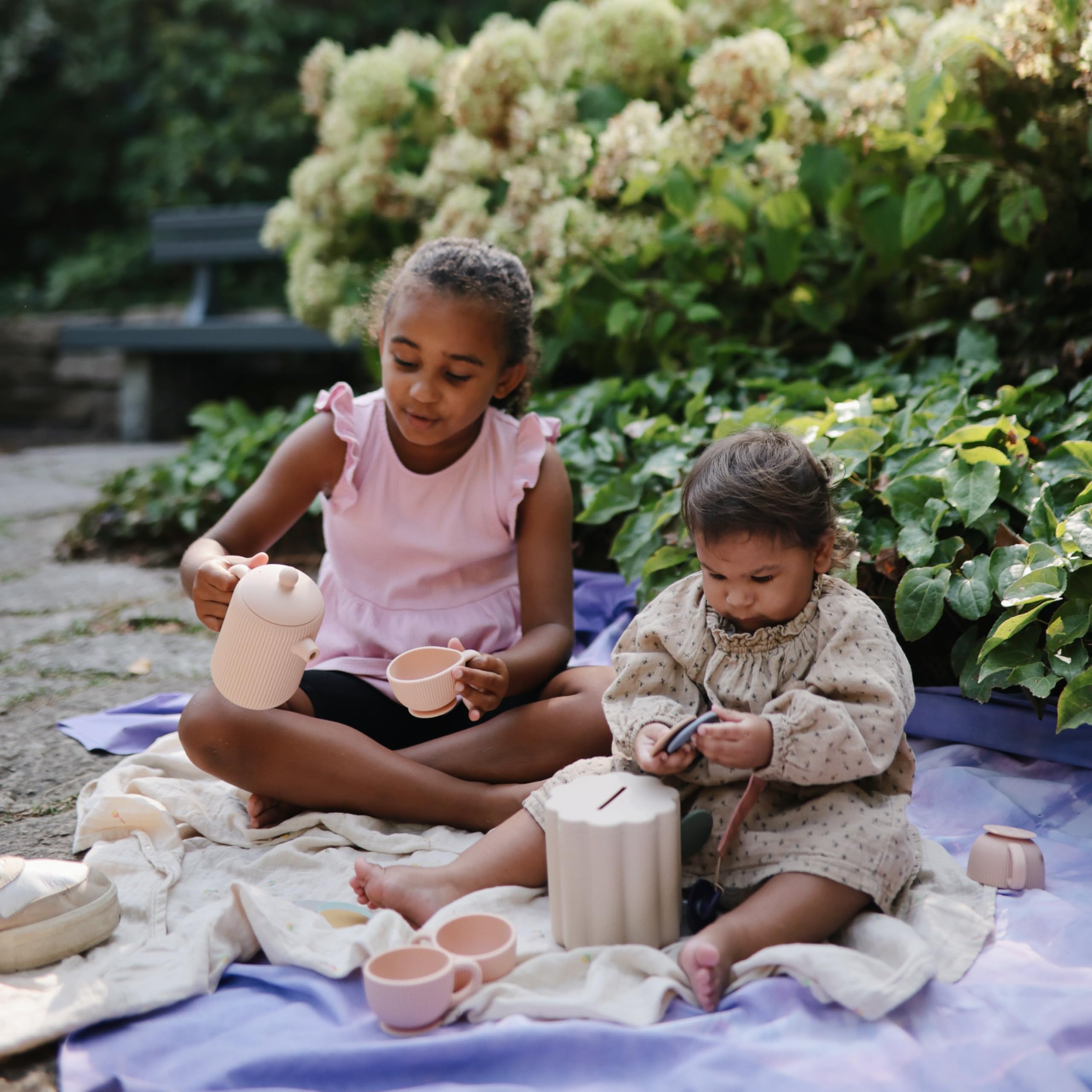 Mushie tea play set in a cozy pretend play scene with kids