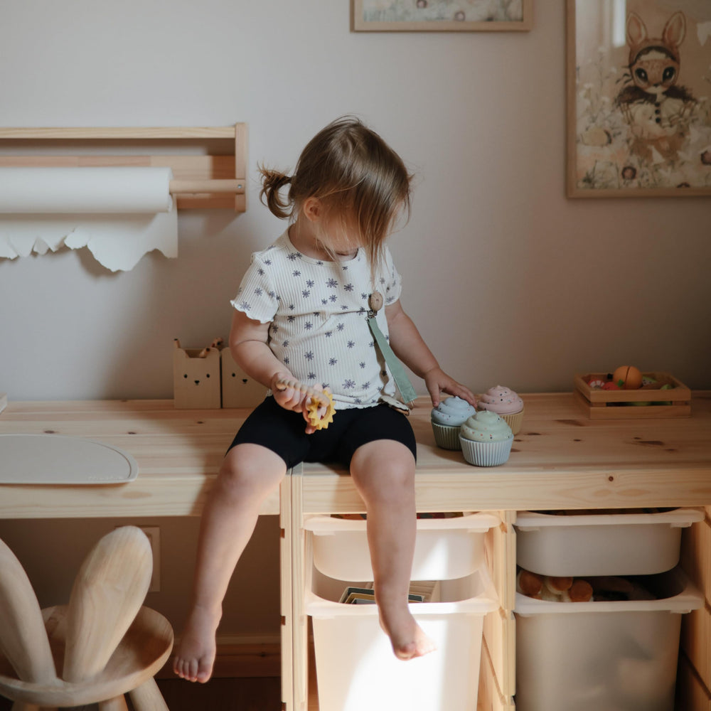 Mushie silicone cupcake toy close-up with smooth edges for gentle teething-inspired play