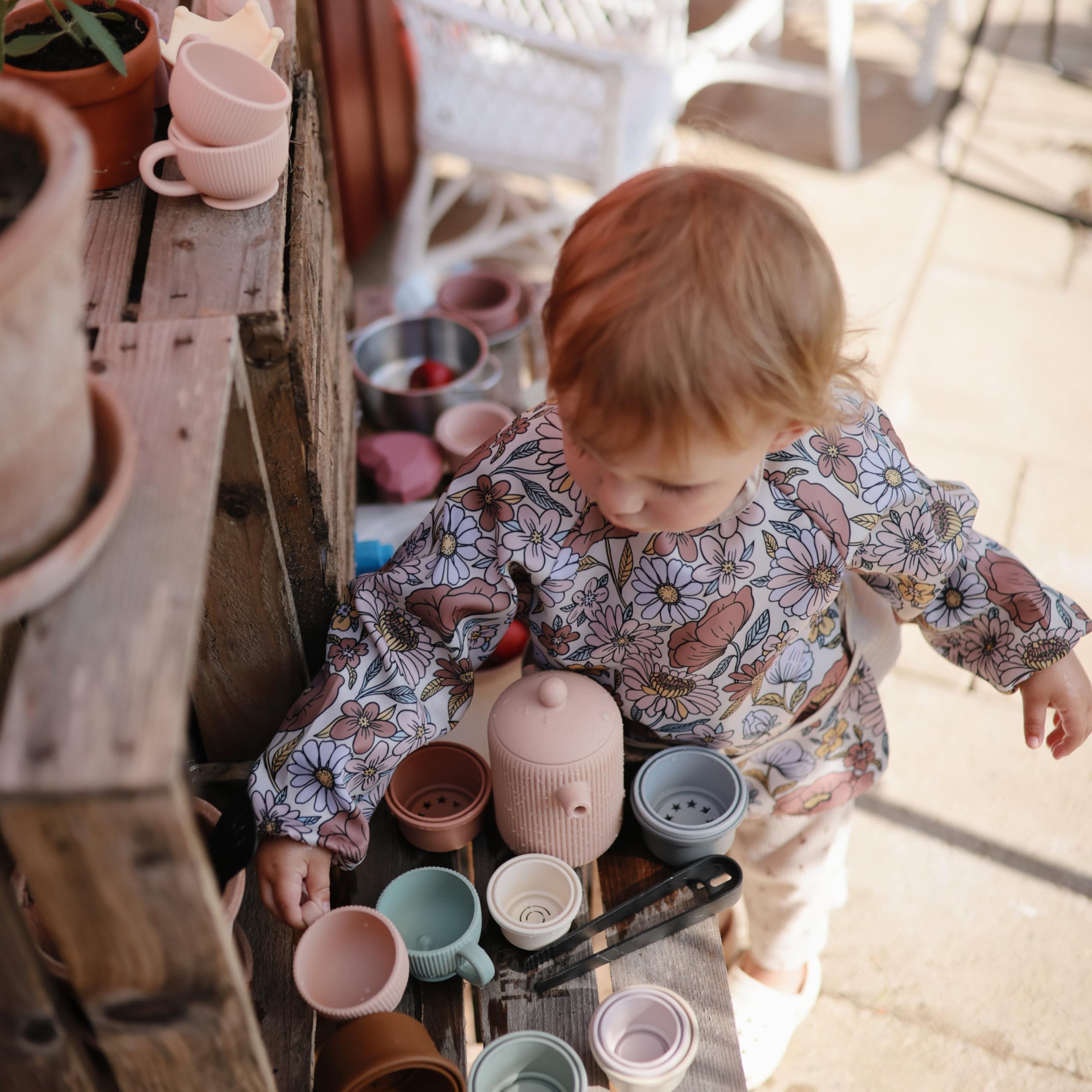 Mushie teacups and teapot promote social interaction during play.