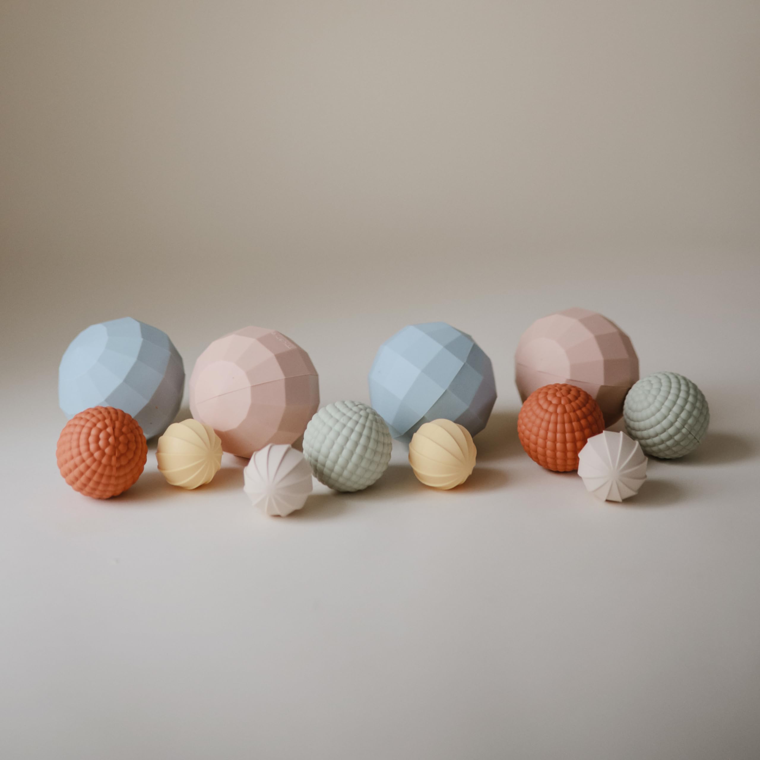 Mushie nesting spheres demonstrating sorting and spatial awareness during play