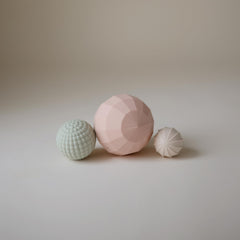 Mushie silicone nesting spheres textures promote baby sensory discovery and fine motor practice