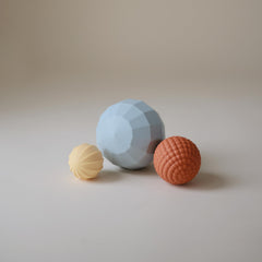 Individual Mushie sphere highlighting color variety and soft silicone surface for safe play