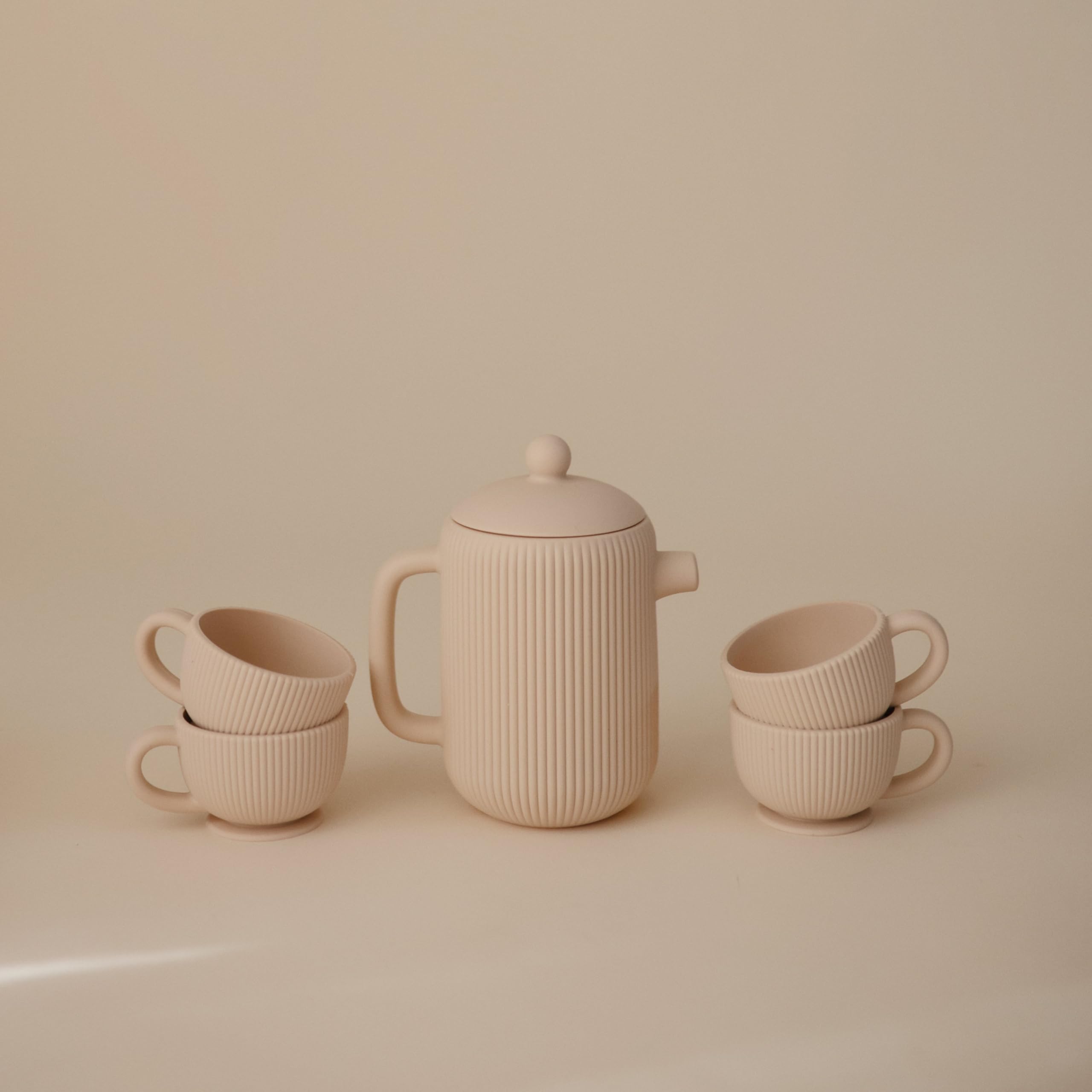 Mushie silicone tea play set teacups close-up highlighting kid friendly size