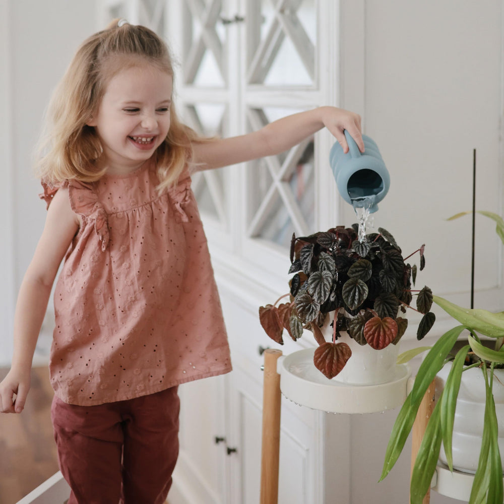 Mushie silicone watering can encouraging pouring and scooping actions