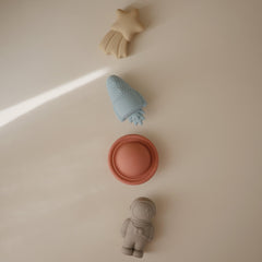 Mushie Space Bath Rocket, bright toy inspires imaginative bathtub adventures.