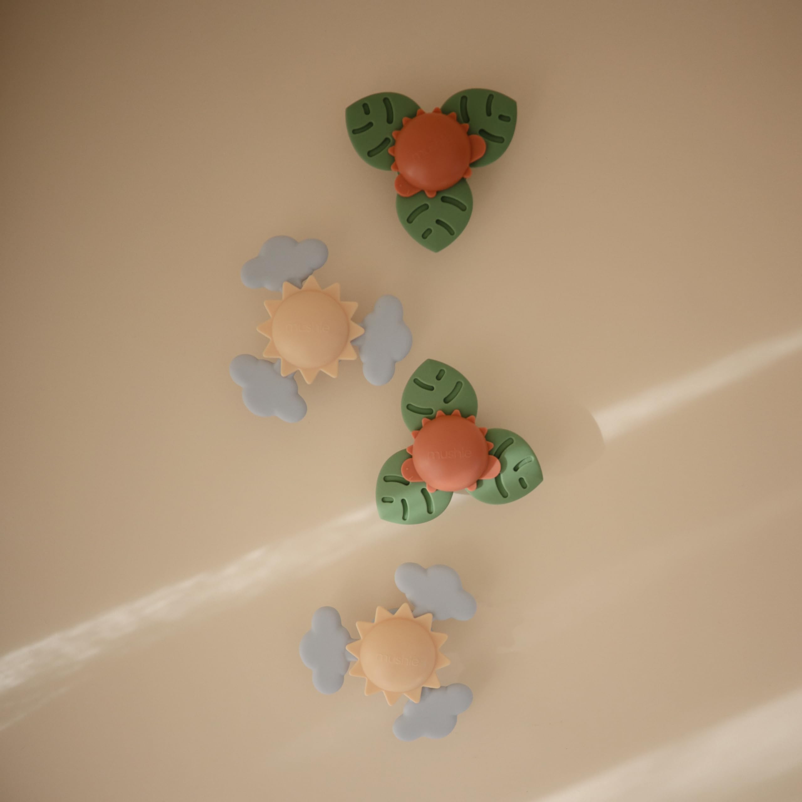 Mushie spinner attached to highchair for mealtime distraction