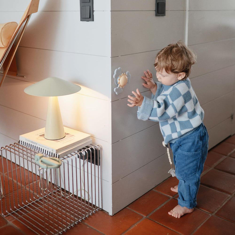 Mushie suction spinner on bathtub edge for splashy sensory play