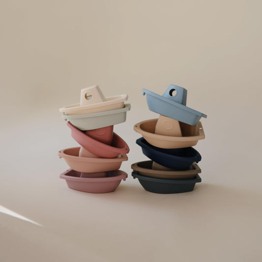 Mushie Ocean boats linked together form a floating train during bath.