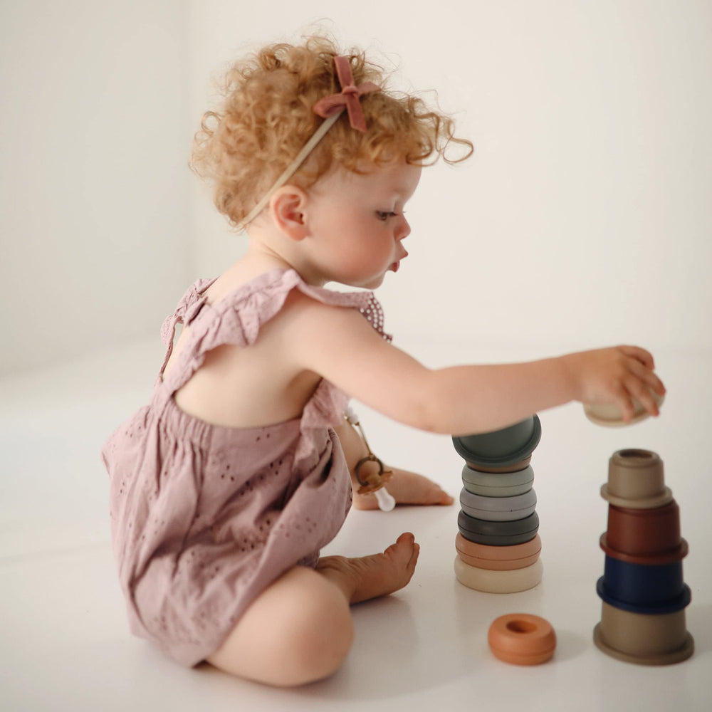 Mushie Stacking Cups Toy encourages baby-first stacking and hand-eye coordination through playful sorting.