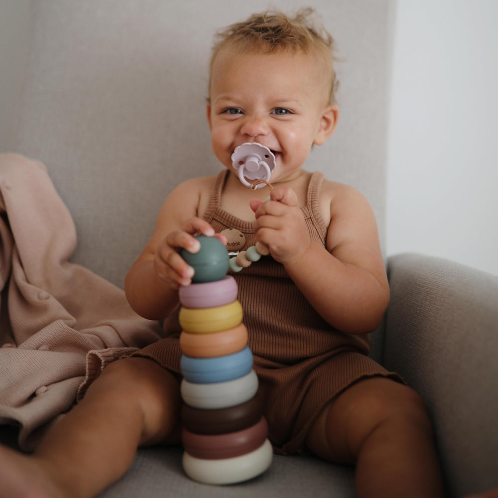 Mushie stacking rings on a mat invite nesting games and color recognition practice