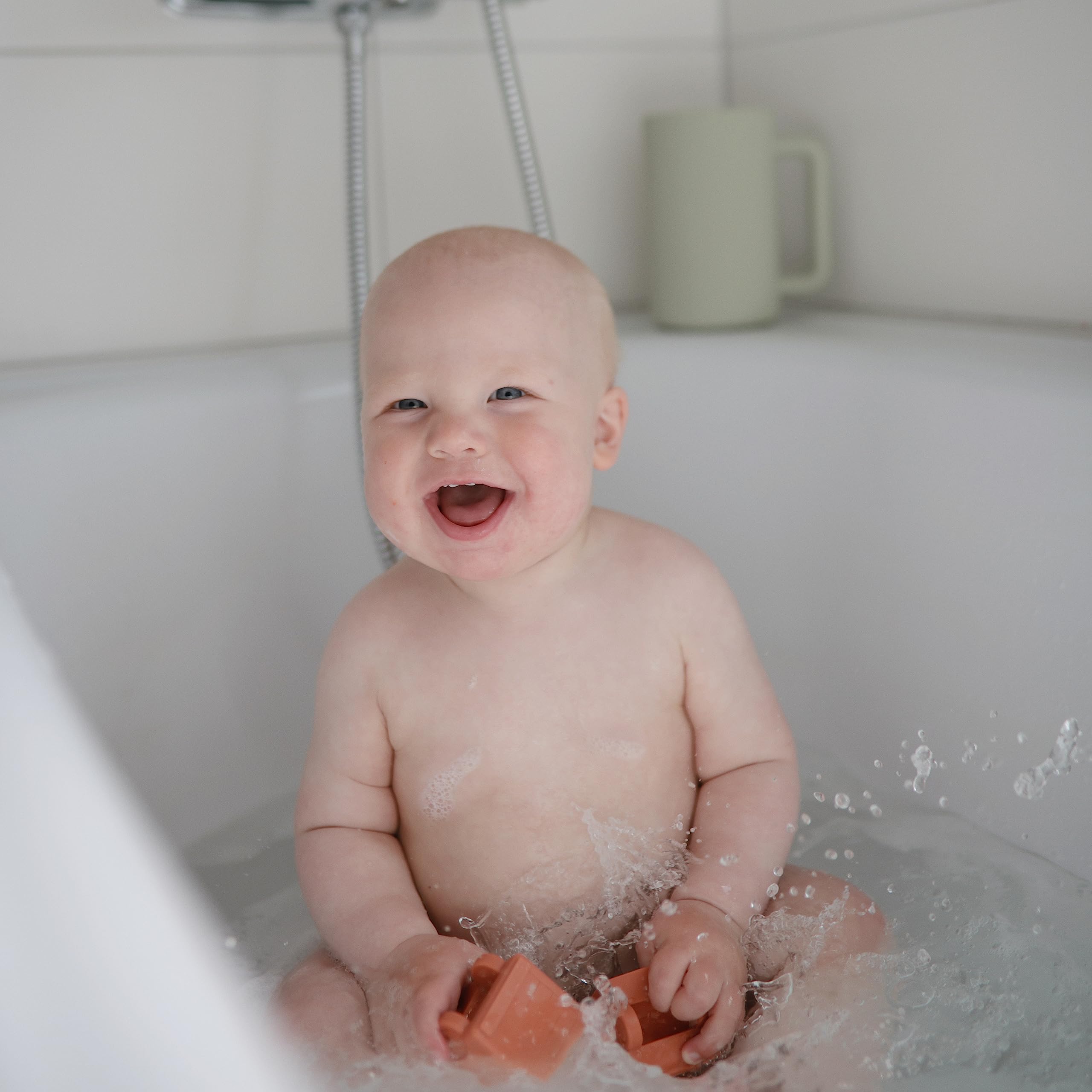 Mushie excavator bath toy: two-piece design for thorough cleaning.