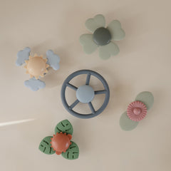 Mushie wheel suction spinner closeup leaves around the dinosaur to promote calm focus