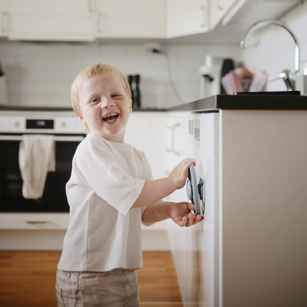 Mushie suction spinner on highchair demonstrates secure grip during independent play