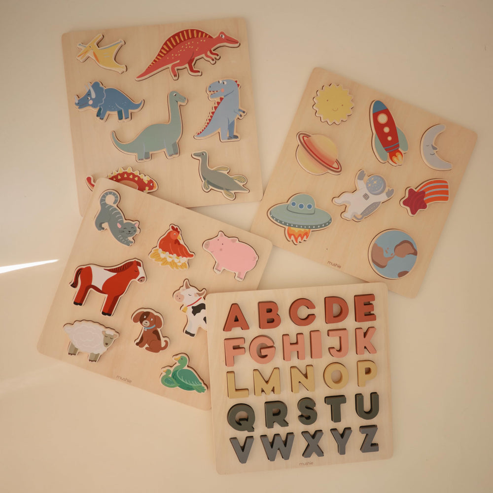 Mushie wooden alphabet puzzle letters assembled for complete alphabet practice.