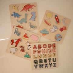 Mushie wooden alphabet puzzle letters assembled for complete alphabet practice.