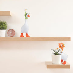 Neowedding desk goose wearing carrot hat brings playful harvest vibes
