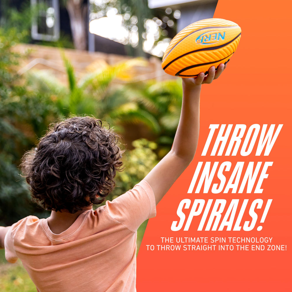 Child holding spiral-grip football ready for backyard play with Nerf logo.