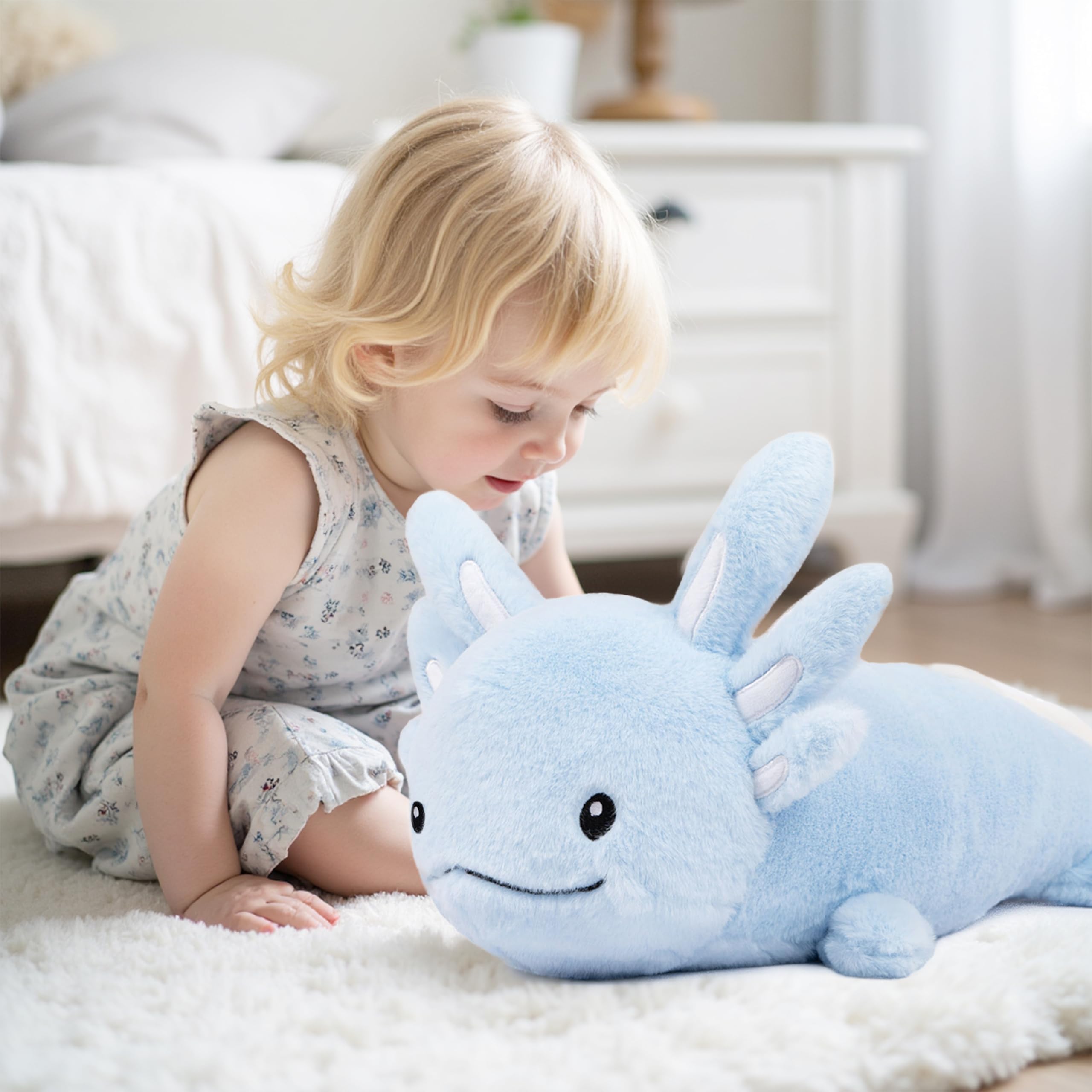 Niuniu Daddy blue axolotl plush resting beside a child during bedtime.