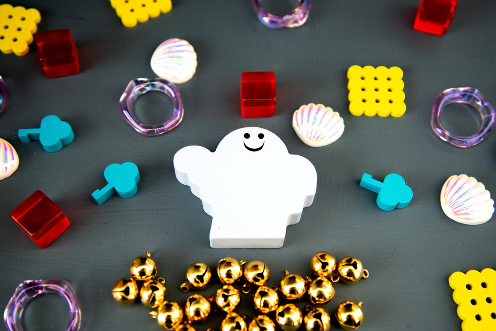 Oink Games DroPolter next to a hand to show size and portability benefit