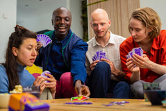 Oink Games Scout player holding cards mid-turn, demonstrating scout-or-show choice