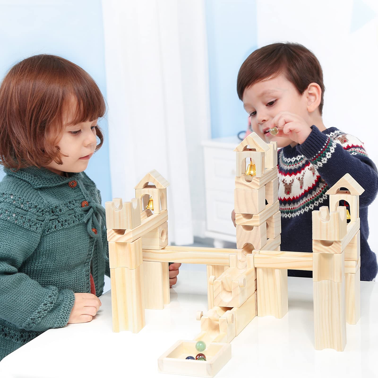 Onshine kids building marble maze: collaborative setup that encourages teamwork.