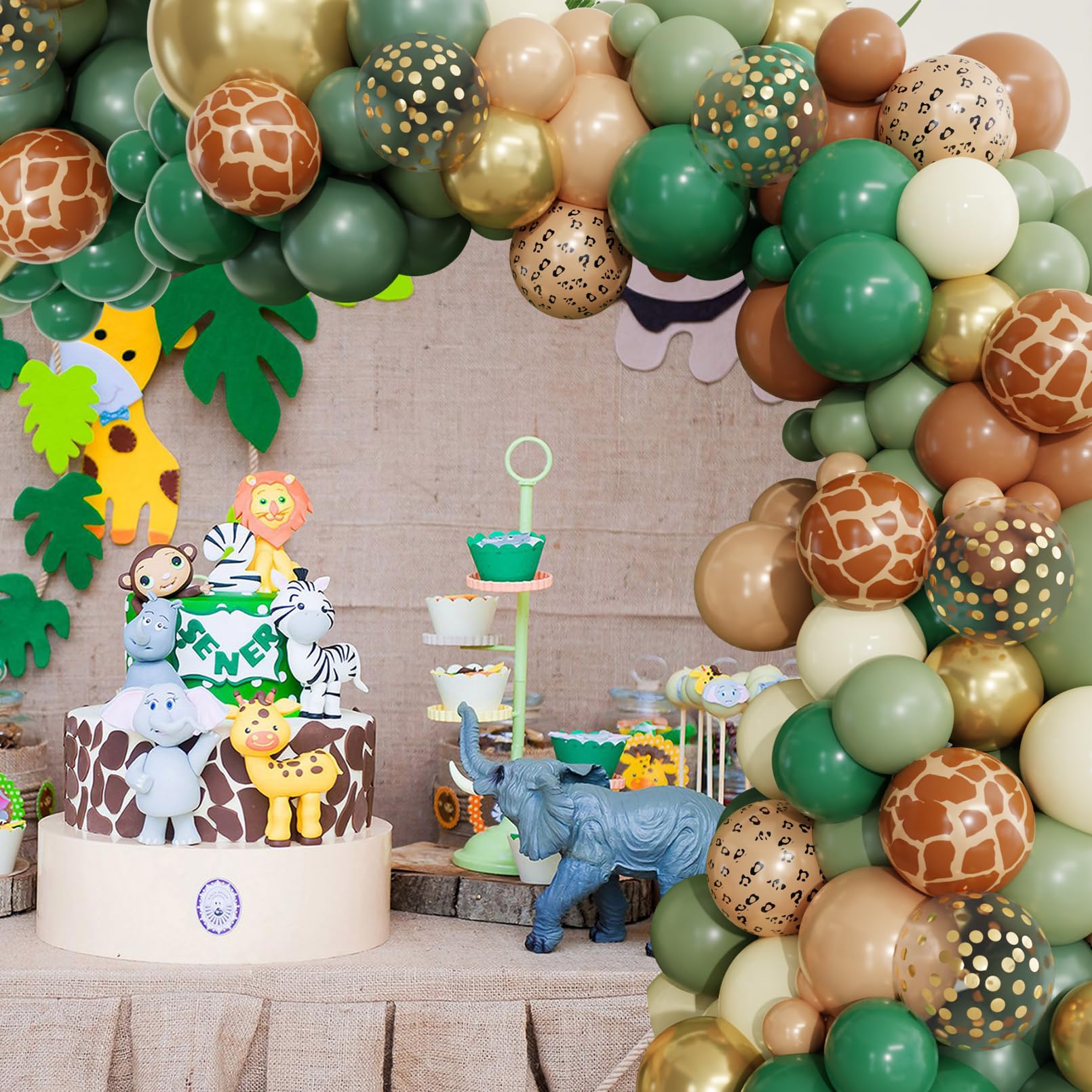 Ouddy Party woodland baby shower setup with greens and prints